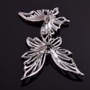 Détail du dos d'une broche papillon en argent montrant le fermoir de sécurité en métal