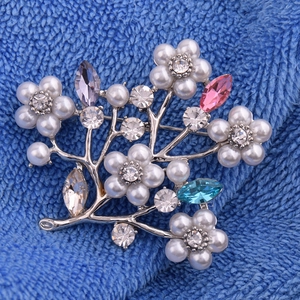 Detail of floral branch brooch with pearls, rhinestones and colorful marquise gems