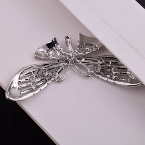 Detailed back view of a dragonfly brooch with a pin clasp and hollow alloy wing structure