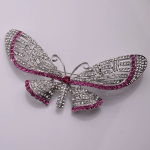 Macro view of crystal butterfly brooch with white and rose pink rhinestones on silver base