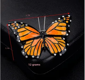 Detail view of rhinestone butterfly brooch showing dimensions 4.7cm by 3.0cm and 12g weight