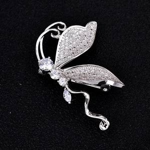 Close-up of silver butterfly brooch with micro-paved cubic zirconia on black background