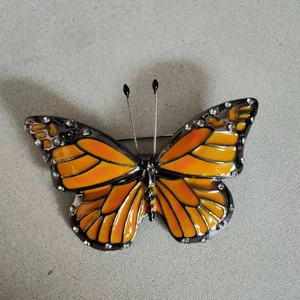Elegant butterfly brooch with orange enamel gradient wings and sparkling rhinestones