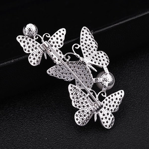 Detailed back view of silver butterfly brooch with secure pin clasp and white pearls