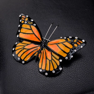 Elegant monarch butterfly brooch with orange drip oil wings and sparkling rhinestones