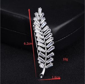 Detailed view showing the 6.2cm leaf brooch dimensions with inlaid baguette-cut zircons