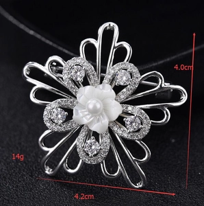 Detail showing shell flower brooch dimensions 4.2cm x 4.0cm with micro-set zircon accents