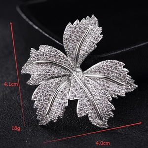 Detailed macro of a silver maple leaf brooch with zircons and measurements 4.1cm x 4.0cm