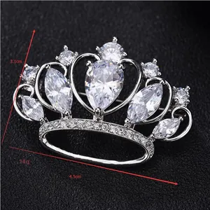 Detailed macro view of crown brooch with AAA cubic zirconia in silver-tone metal