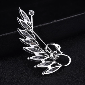Detailed back view of the swan brooch showing silver metal base and pin closure mechanism