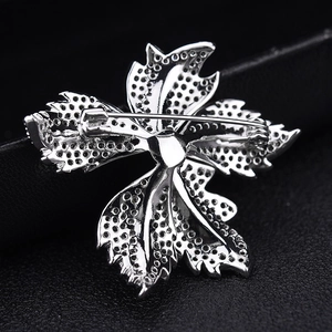 Leaf shaped zircon brooch showing silver metal back detail and safety pin clasp