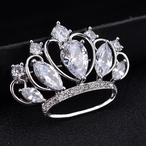 Macro detail of high-quality crown brooch with AAA cubic zirconia on black leather