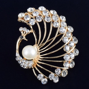 Elegant gold peacock brooch with sparkling rhinestones and a large round white pearl