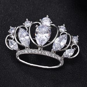 Elegant crown brooch with sparkling AAA zircon inlay in silver setting on black texture