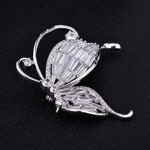 Macro shot of sparkling butterfly brooch featuring baguette and round cubic zirconia