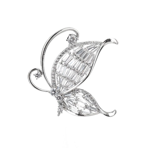 Elegant silver butterfly brooch with baguette and round diamonds on a white background