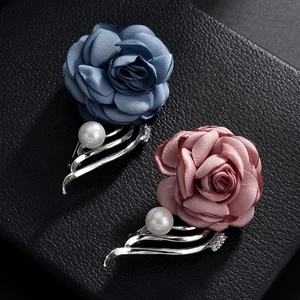 Elegant camellia fabric brooches with pearls and rhinestones on black background