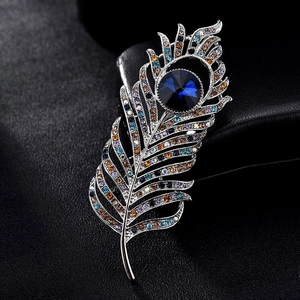 Elegant silver peacock feather brooch with deep blue main stone and multicolor rhinestones