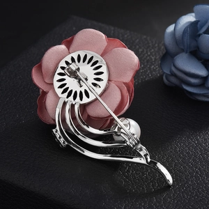 Detailed back view of fabric flower brooch showing silver metal base and pearl inlay