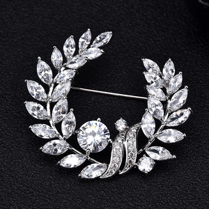 Macro detail of laurel leaf brooch with silver finish and marquise-cut crystal zircon