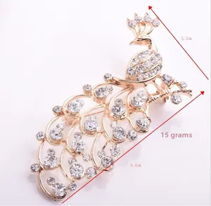 Detailed view of a golden peacock brooch showing dimensions 6.6cm by 3.2cm and weight 15g