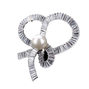 Elegant bow brooch with silver alloy base, inlaid zircons and a central white pearl