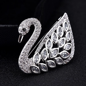 Macro shot of silver swan brooch showing marquise-cut crystals and intricate pavé detail