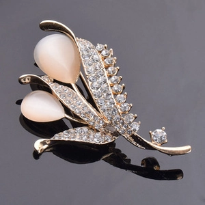 Detail of flower brooch with pear-shaped cat eye stones and sparkling rhinestones