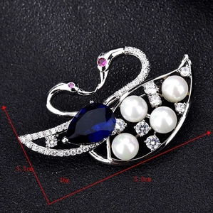 Macro view of blue swan brooch with dimensions showing pearls and crystal detail