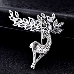 Silver crystal reindeer brooch featuring honeycomb back structure and safety pin closure