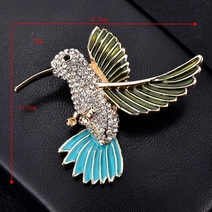 Detailed view of enamel hummingbird brooch size 6.0cm by 5.0cm with 18g weight spec