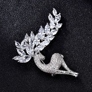 Sparkling crystal deer brooch with marquise-cut antlers on premium black leather surface