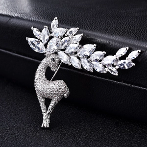 Macro shot of silver deer brooch with white zircon pavé and marquise crystal antlers