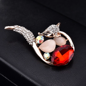 Elegant gold fox brooch featuring opal stones, red crystal, and sparkling rhinestones