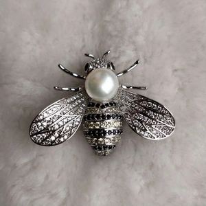 Detail der Bienenbrosche mit weißer Perle, Zirkonia-Besatz und silbernem Metall-Finish