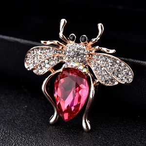 Exquise broche abeille dorée avec cristal rouge poire et micro-pavage de zircons clairs