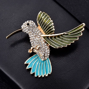 Exquisite gold-plated hummingbird brooch with vibrant enamel wings and sparkling rhinestones