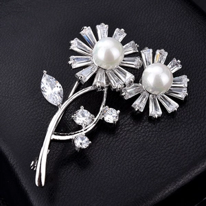 Elegant silver flower brooch with white pearls and sparkling zircons on black leather