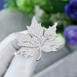 Luxury maple leaf brooch with sparkling zircons on a silver metal base jewelry