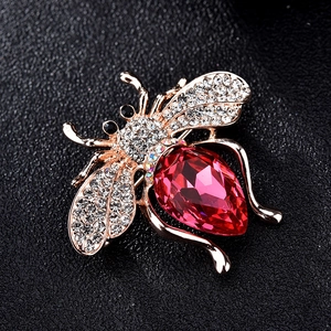 Macro de la broche abeille avec cristal rouge en goutte et micro-pavage de zircons