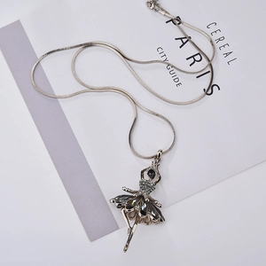 Detail of silver ballet dancer pendant with dark crystals and smooth snake chain