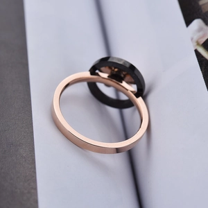 Minimalist geometric rotating snowflake ring in rose gold finish with black circular accent