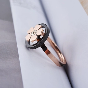 Macro shot of spinning snowflake ring in rose gold with black accents and crystal
