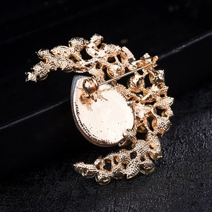 Macro detail of vintage crystal brooch back with safety pin and hollowed golden honeycomb alloy