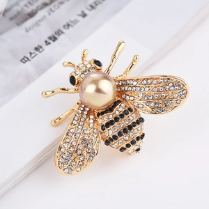 Broche abeille dorée élégante avec perle champagne et strass scintillants de luxe
