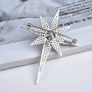 Detail view of the star brooch back side featuring a secure silver safety pin clasp