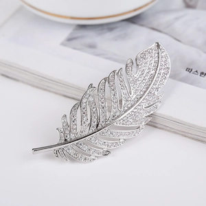 Elegant feather brooch with silver-tone metal and shimmering cubic zirconia stones