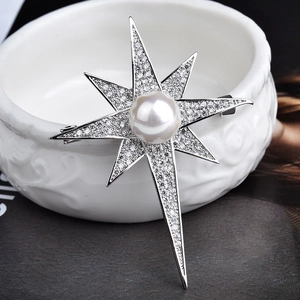 Elegant silver starburst brooch with sparkling zircon stones and a central white pearl