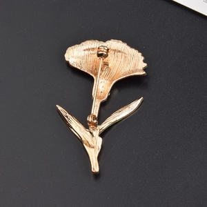 Detailed back view of golden carnation brooch showing metal texture and pin fastener