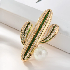 Broche de cactus dorado con esmalte verde, cristales brillantes y una perla blanca fina